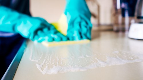 Professional cleaner working in a flat and common areas in SW20